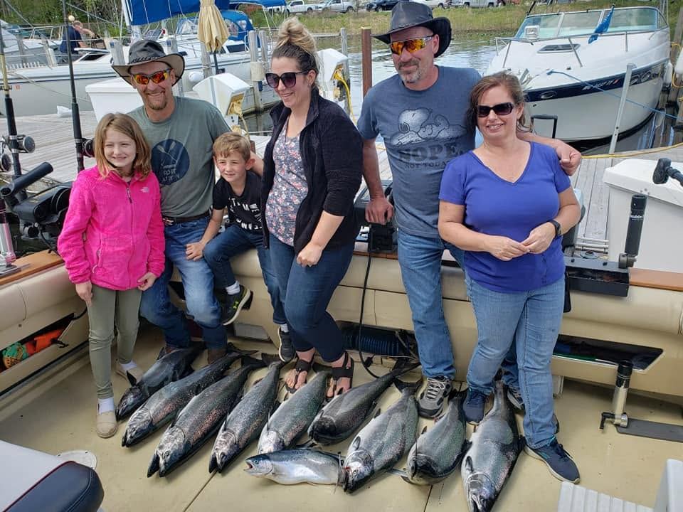 A family charter trip with a full lineup of salmon at the dock