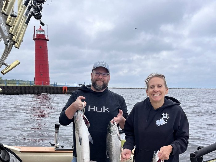 Guests with a nice catch of king salmon near the Muskegon pierhead lighthouse