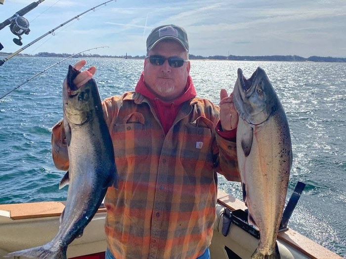 Angler with a double hookup of king salmon aboard the Double Down
