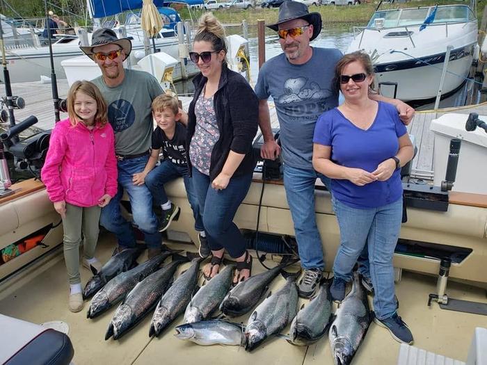 A family charter trip with a full lineup of salmon at the dock